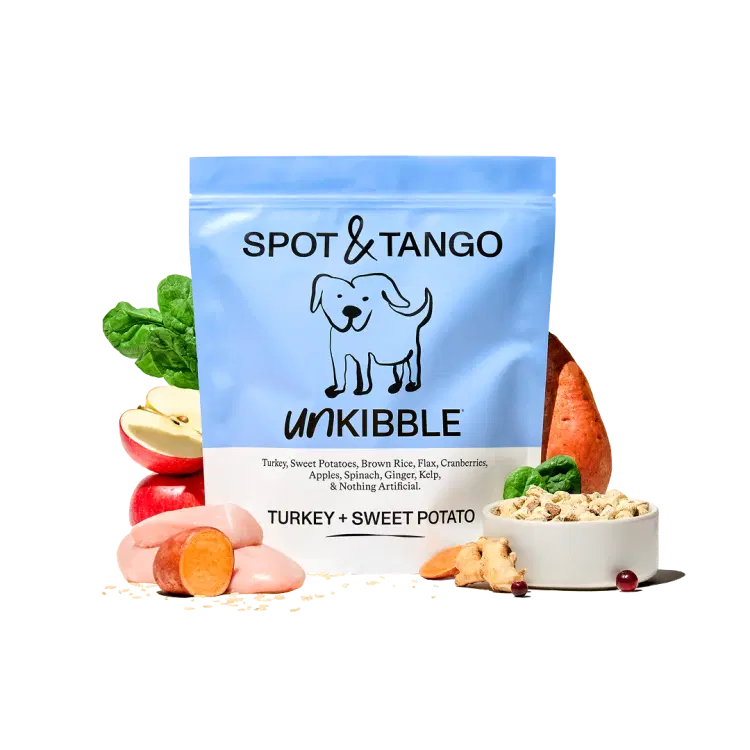 A bag of Turkey and Sweet Potato UnKibble surrounded by turkey, apples, sweet potatoes and other fresh produce